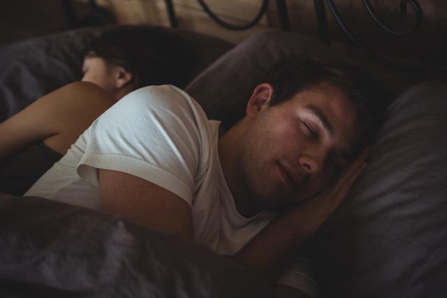 Couple sleeping on bed in the bedroom- Download Free Stock Photos Pikwizard.com