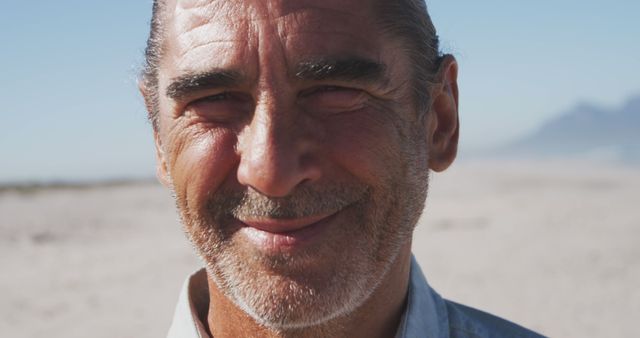 Portrait of happy senior caucasian man smiling on beach - Download Free Stock Photos Pikwizard.com