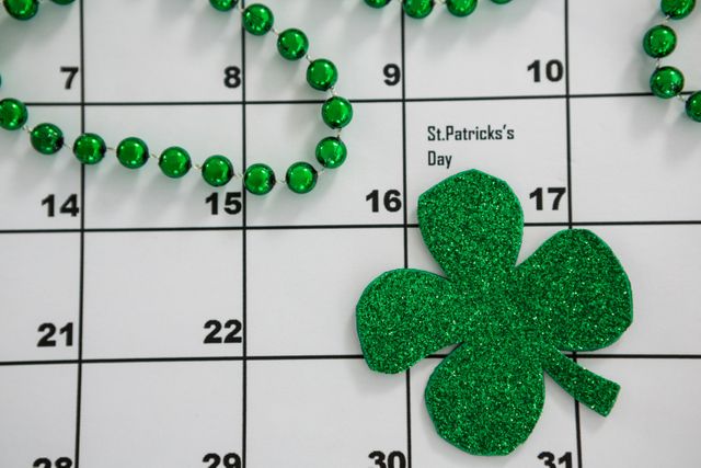 St. Patricks Day shamrock and beads kept on calendar - Download Free Stock Photos Pikwizard.com