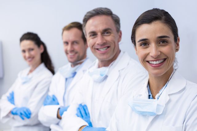 Smiling dentists standing with arms crossed - Download Free Stock Photos Pikwizard.com