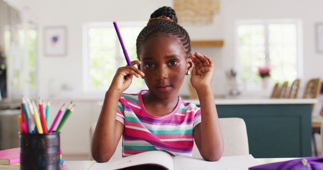 Image of thoughtful african american girl during online lesson, copy space. Childhood, education, learning, communication, inclusivity and domestic life.