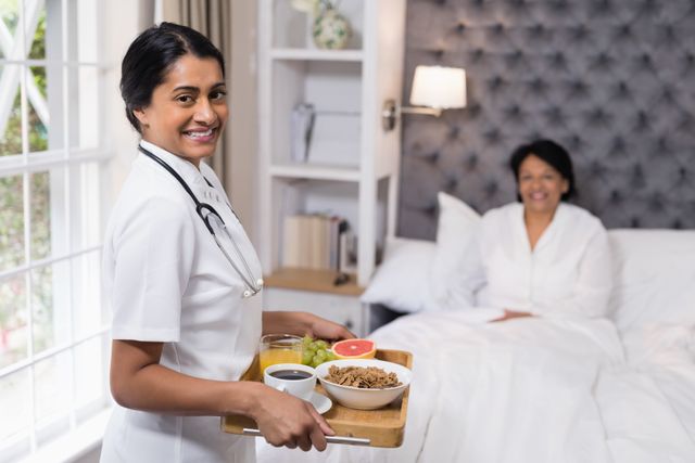 Portrait of nurse serving breakfast to patient at home - Download Free Stock Photos Pikwizard.com