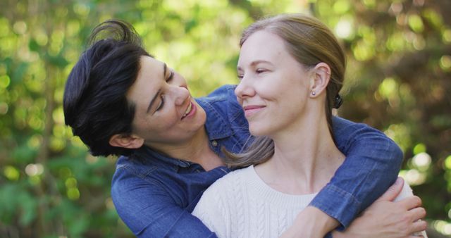 Happy caucasian lesbian couple embracing each other in the garden. lgbt relationship and lifestyle concept