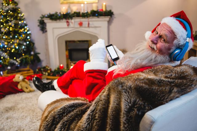 Santa claus using mobile phone at home - Download Free Stock Photos Pikwizard.com