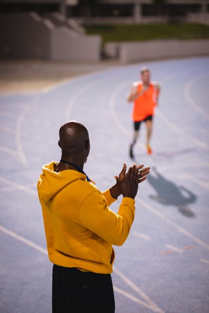 Back view of african american male coach with clapping hands during training - Download Free Stock Photos Pikwizard.com