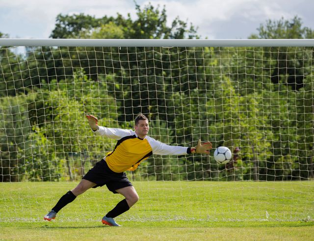 Goalkeeper diving to save the goal - Download Free Stock Photos Pikwizard.com