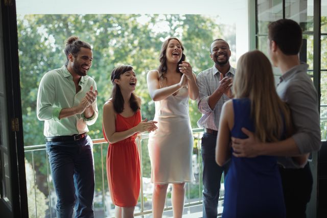 Group of friends applauding couple during party - Download Free Stock Photos Pikwizard.com