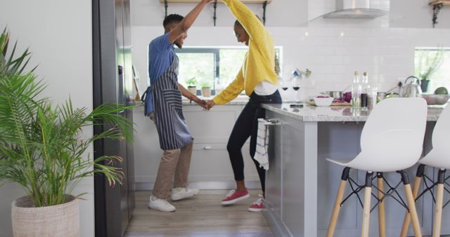 Happy african american couple dancing in kitchen - Download Free Stock Photos Pikwizard.com