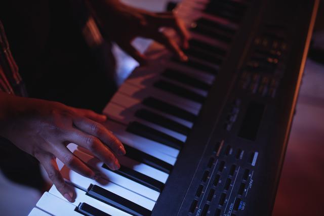 Mid section of musician playing electronic piano in studio - Download Free Stock Photos Pikwizard.com