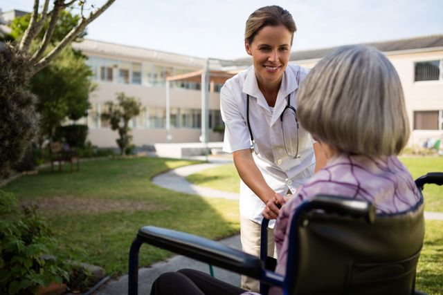 Doctor talking to senior woman sitting on wheelchair - Download Free Stock Photos Pikwizard.com
