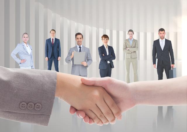Business executives shaking hands while colleagues standing in background - Download Free Stock Photos Pikwizard.com