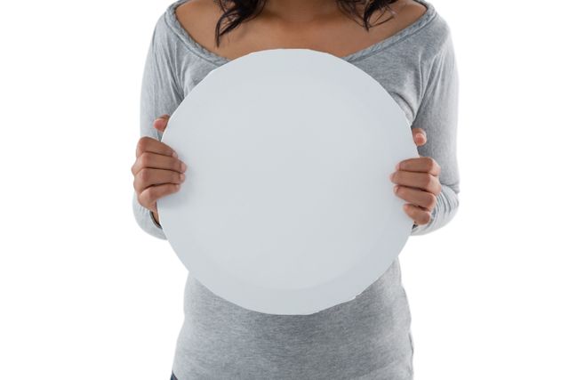 Mid section of woman holding circle shaped placard - Download Free Stock Photos Pikwizard.com