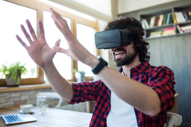 Happy man using virtual reality headset - Download Free Stock Photos Pikwizard.com
