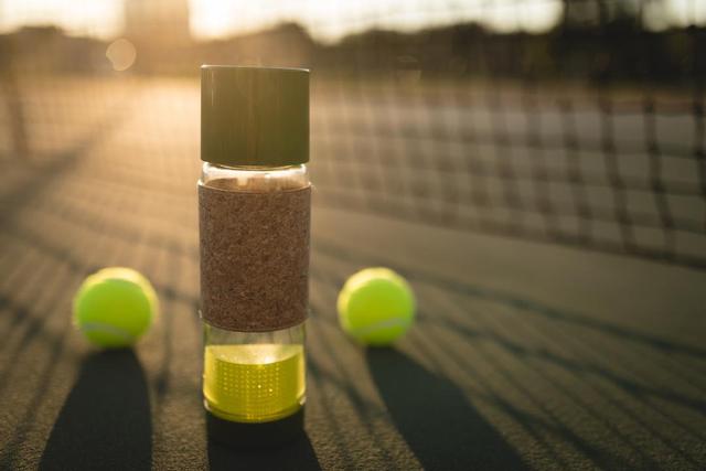Close-up of tennis ball and water bottle in ground - Download Free Stock Photos Pikwizard.com