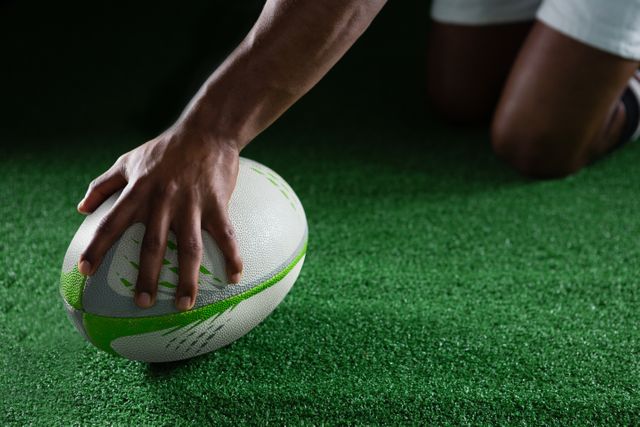Close up of sportsman holding rugby ball - Download Free Stock Photos Pikwizard.com