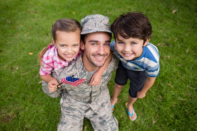 Happy soldier reunited with his son and daughter in park - Download Free Stock Photos Pikwizard.com