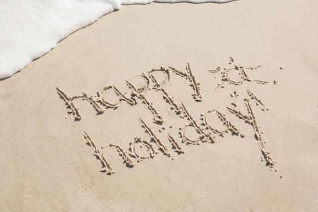 Happy holiday written on sand - Download Free Stock Photos Pikwizard.com