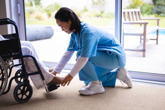 Asian female nurse taking care of senior patient on wheelchair - Download Free Stock Photos Pikwizard.com