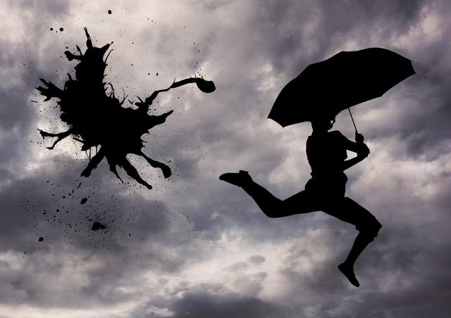 Silhouette of person jumping with an umbrella on stormy weather - Download Free Stock Photos Pikwizard.com