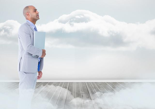 Businessman with laptop standing on floor in clouds - Download Free Stock Photos Pikwizard.com
