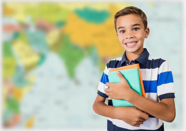 Boy holding books against blurry map - Download Free Stock Photos Pikwizard.com