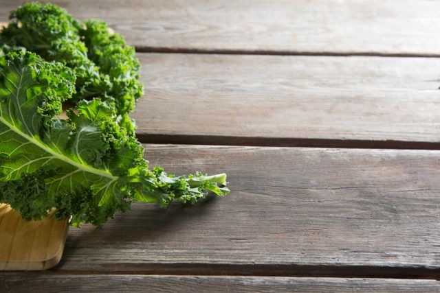 Close up of fresh kale leaves on wooden table