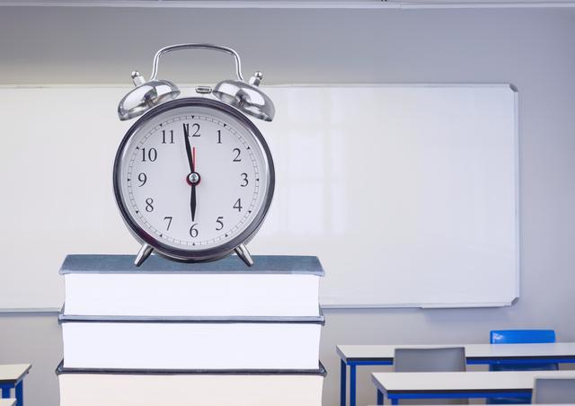 Digital composition of alarm clock on books in classroom - Download Free Stock Photos Pikwizard.com