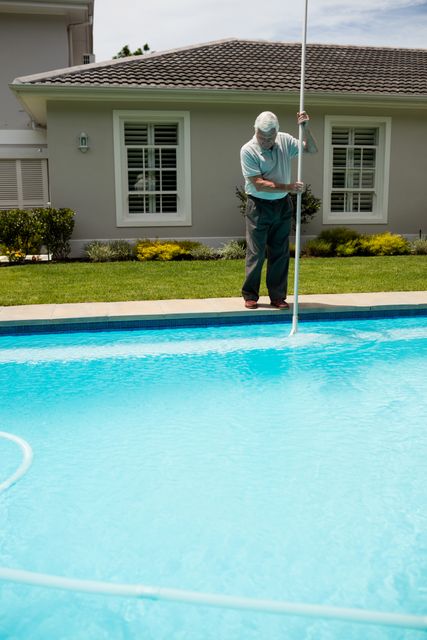 Senior man cleaning swimming pool - Download Free Stock Photos Pikwizard.com