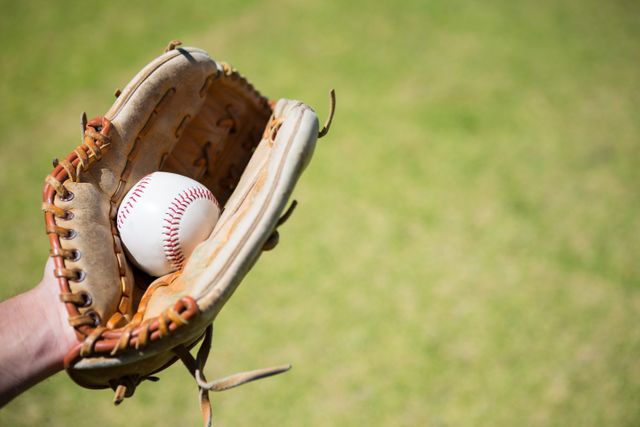 Cropped hand of baseball pitcher holding ball in glove - Download Free Stock Photos Pikwizard.com
