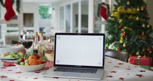 Laptop with copy space on screen lying on christmas table. christmas, festivity and communication technology.