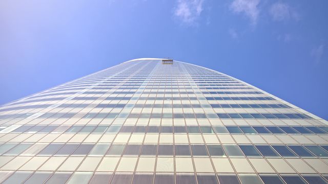 Low angle view of modern office building against sky - Download Free Stock Photos Pikwizard.com