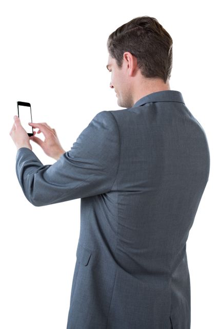 Businessman using mobile phone against white background