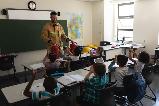 Schoolkids applauding while male Caucasian firefighter teaching about fire safety in classroom - Download Free Stock Photos Pikwizard.com
