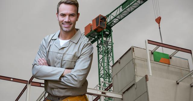 Handyman standing with arms crossed against construction site - Download Free Stock Photos Pikwizard.com