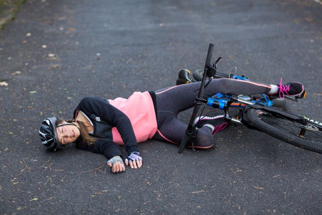 Female biker fallen from her mountain bike - Download Free Stock Photos Pikwizard.com