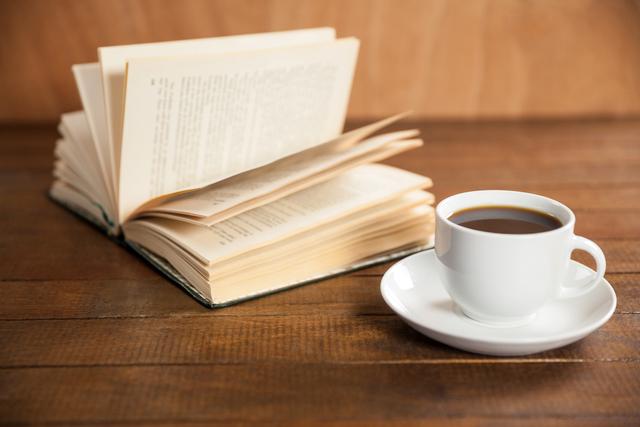Close-up of coffee cup and book - Download Free Stock Photos Pikwizard.com