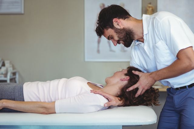 Physiotherapist giving neck massage to a woman - Download Free Stock Photos Pikwizard.com