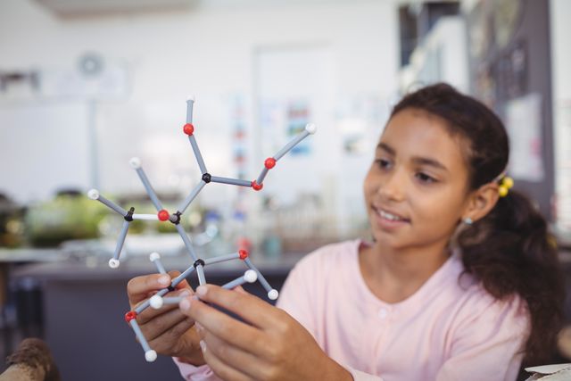 Elementary student holding molecule model - Download Free Stock Photos Pikwizard.com