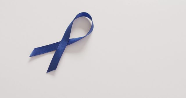Image of dark blue colon cancer ribbon on white background from