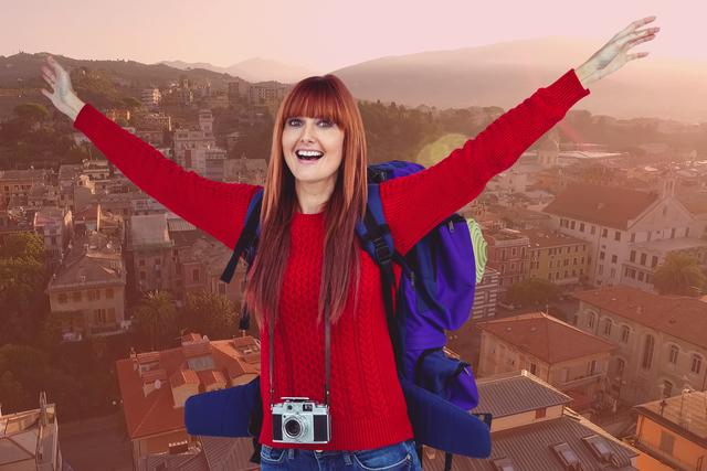 Digital composite of Portrait of cheerful female tourist with buildings in background