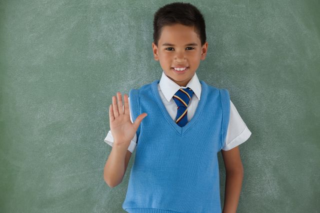 Schoolboy raising hand in classroom - Download Free Stock Photos Pikwizard.com