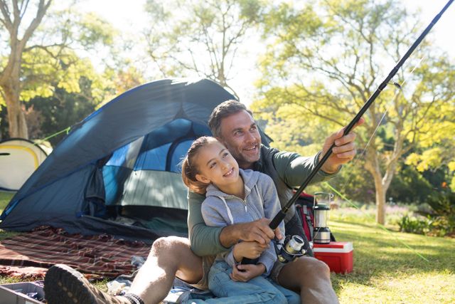 Father and daughter holding a fishing rod outside the tent - Download Free Stock Photos Pikwizard.com