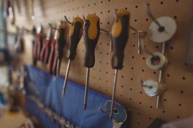 Close up of work tools hanging on rack at workshop - Download Free Stock Photos Pikwizard.com