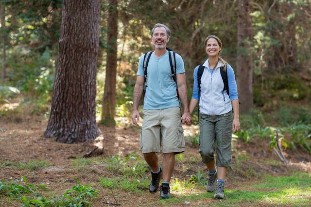 Hiker couple hiking in forest - Download Free Stock Photos Pikwizard.com