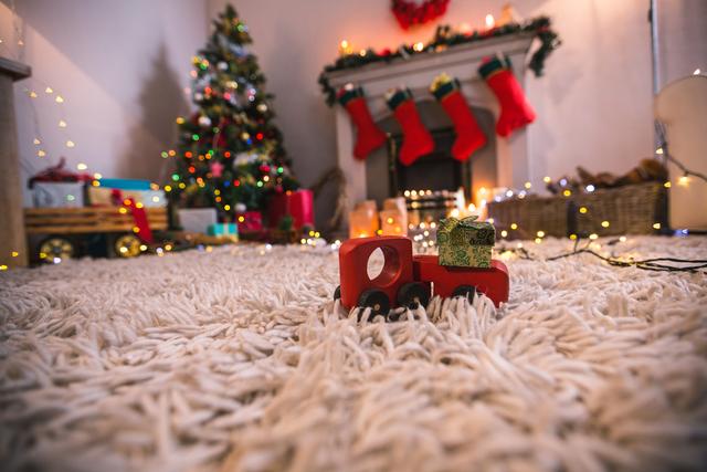 Toy car carrying christmas gift box on fur carpet