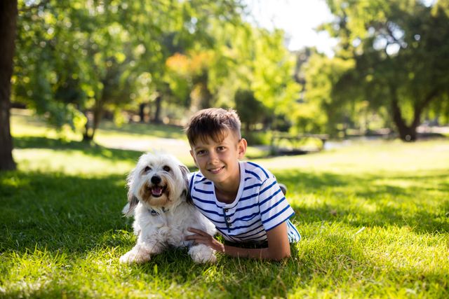 Portrait of boy with dog in park - Download Free Stock Photos Pikwizard.com