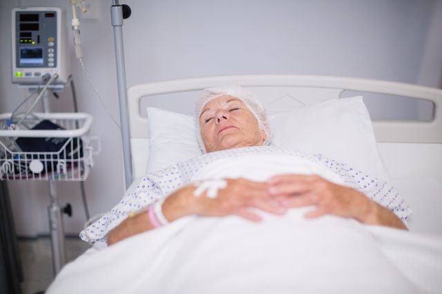 Senior woman patient lying on bed - Download Free Stock Photos Pikwizard.com