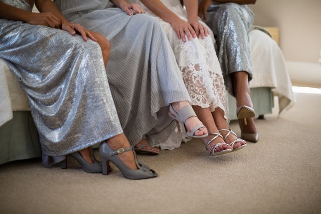 Bride and bridesmaids sitting together on sofa - Download Free Stock Photos Pikwizard.com