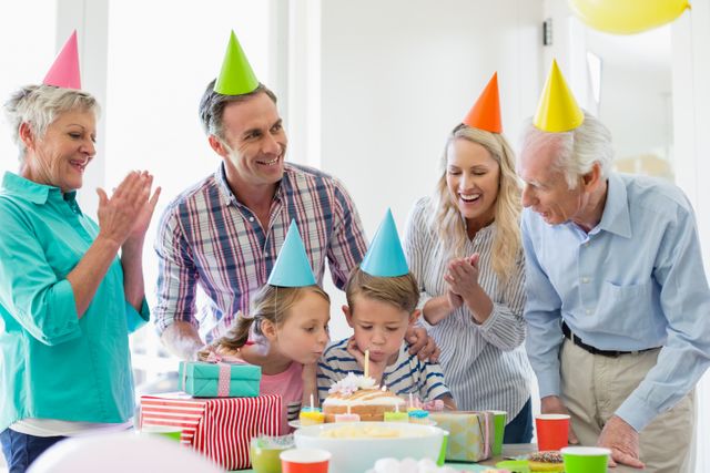 Happy multi- generation family celebrating a birthday- Download Free Stock Photos Pikwizard.com