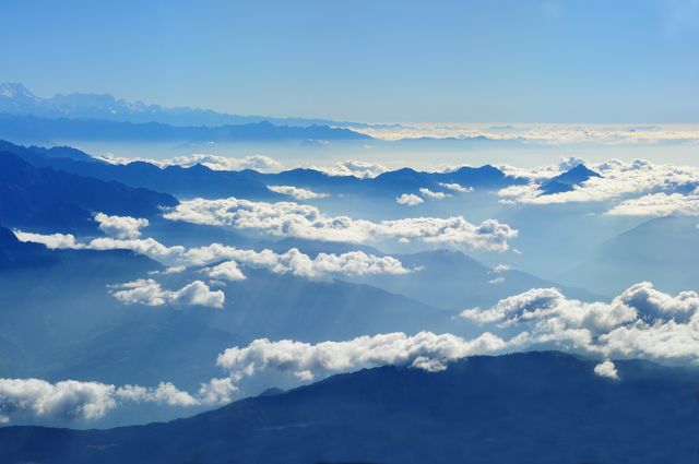 Scenic View of Clouds over Mountains Against Blue Sky - Download Free Stock Photos Pikwizard.com